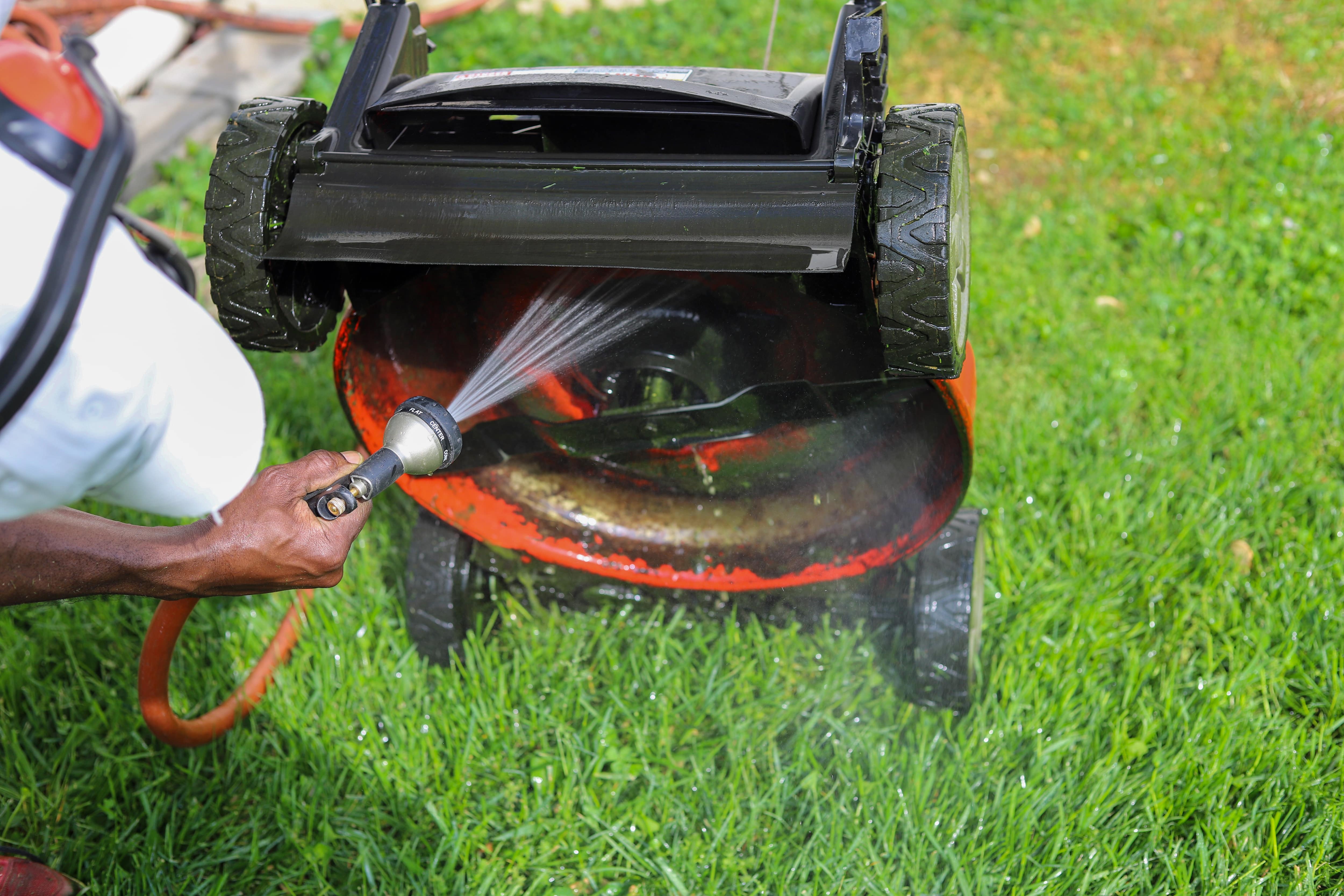 Cleaning lawn mower with a hose