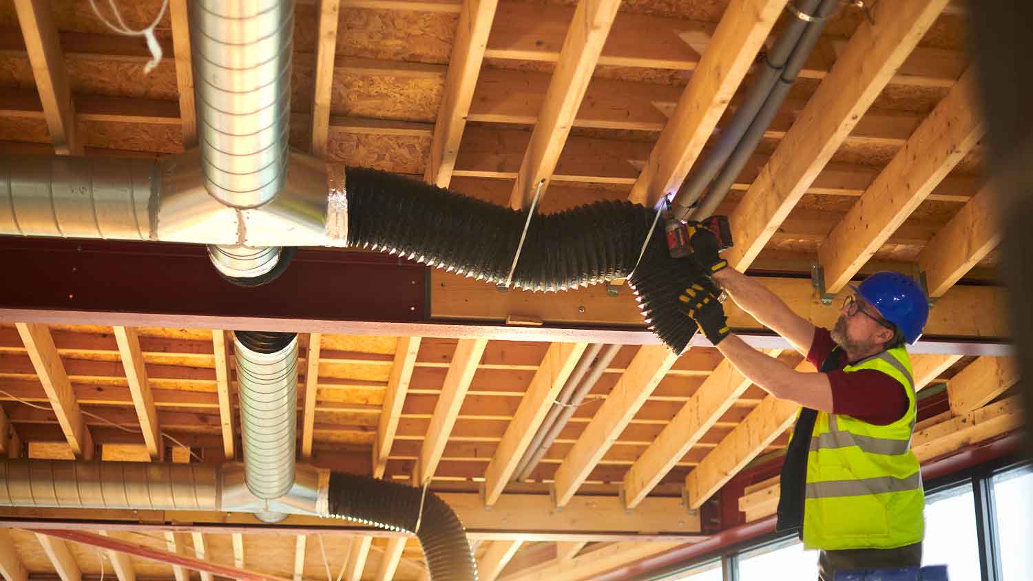 Contractor installing new HVAC air duct system