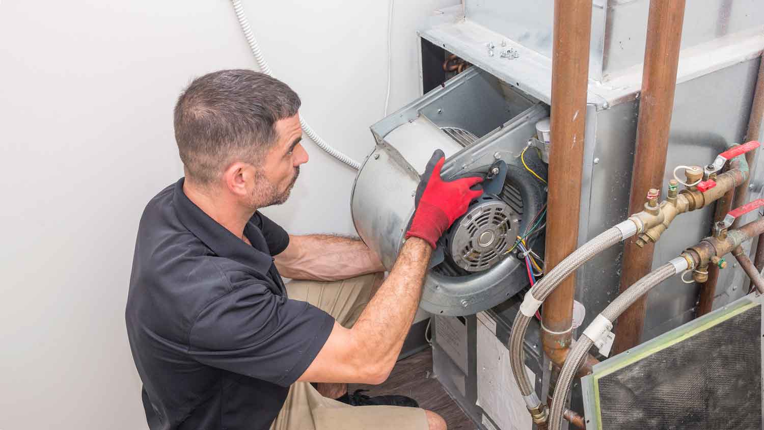 HVAC specialist installing furnace blower motor 