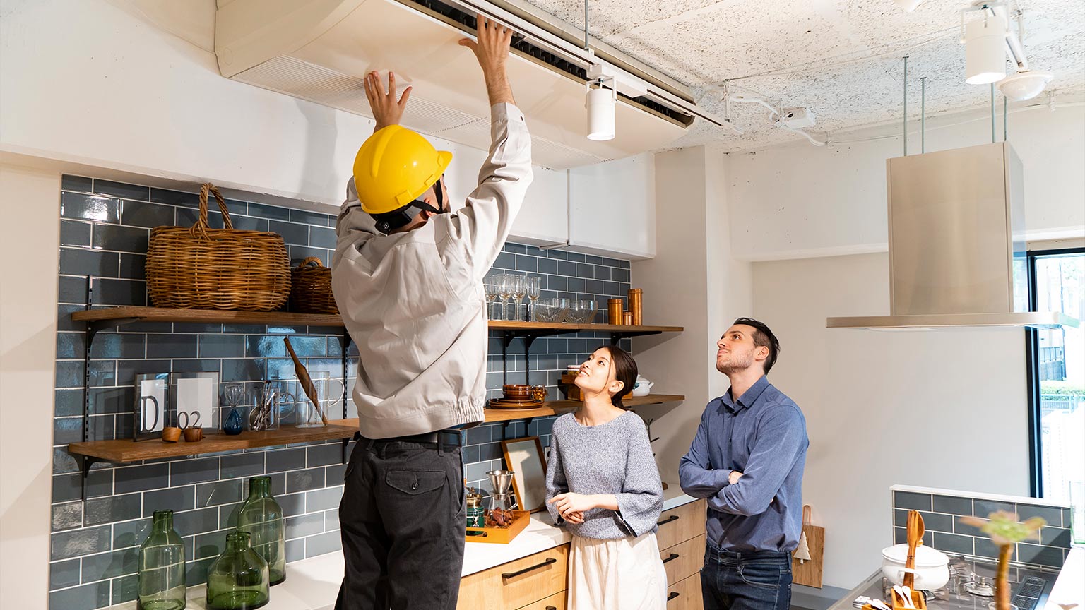 A repairman checking the air conditioner