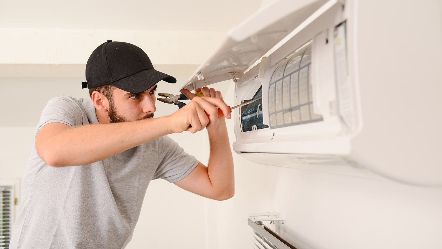 repairman fixing an HVAC