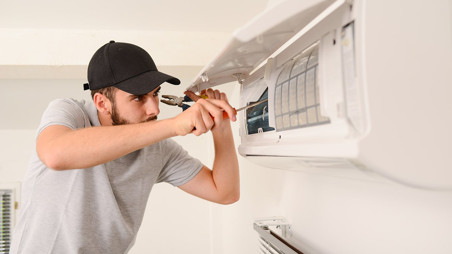 repairman fixing an HVAC 