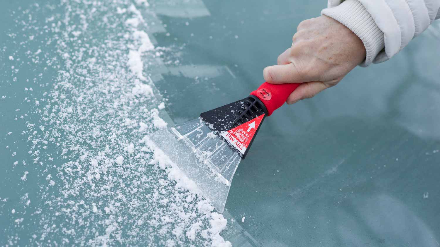 An ice scraper on a car’s windshield