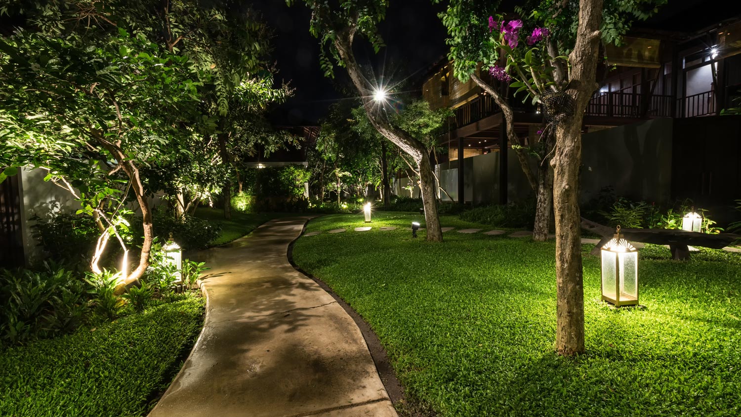 A house’s illuminated concrete walkway at night