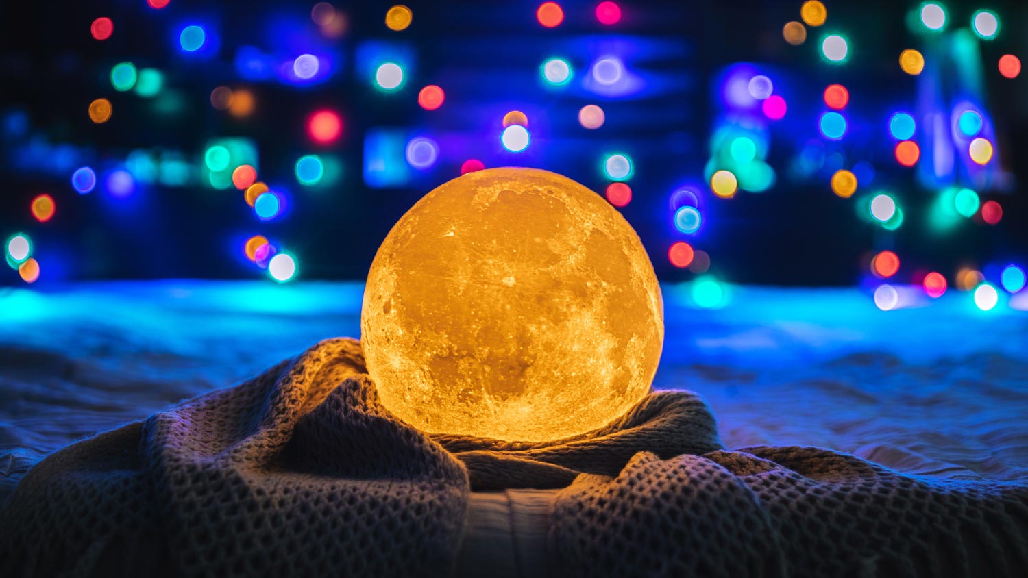 An illuminated moon crystal lamp on textile