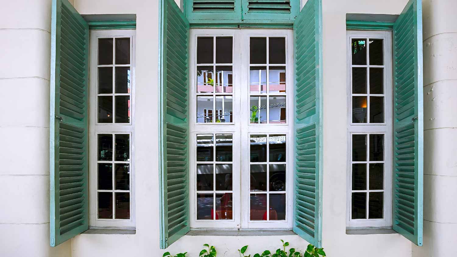 An impact window with hurricane shutters 