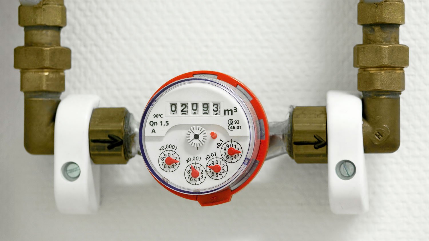 Indoor water meter mounted on a white wall