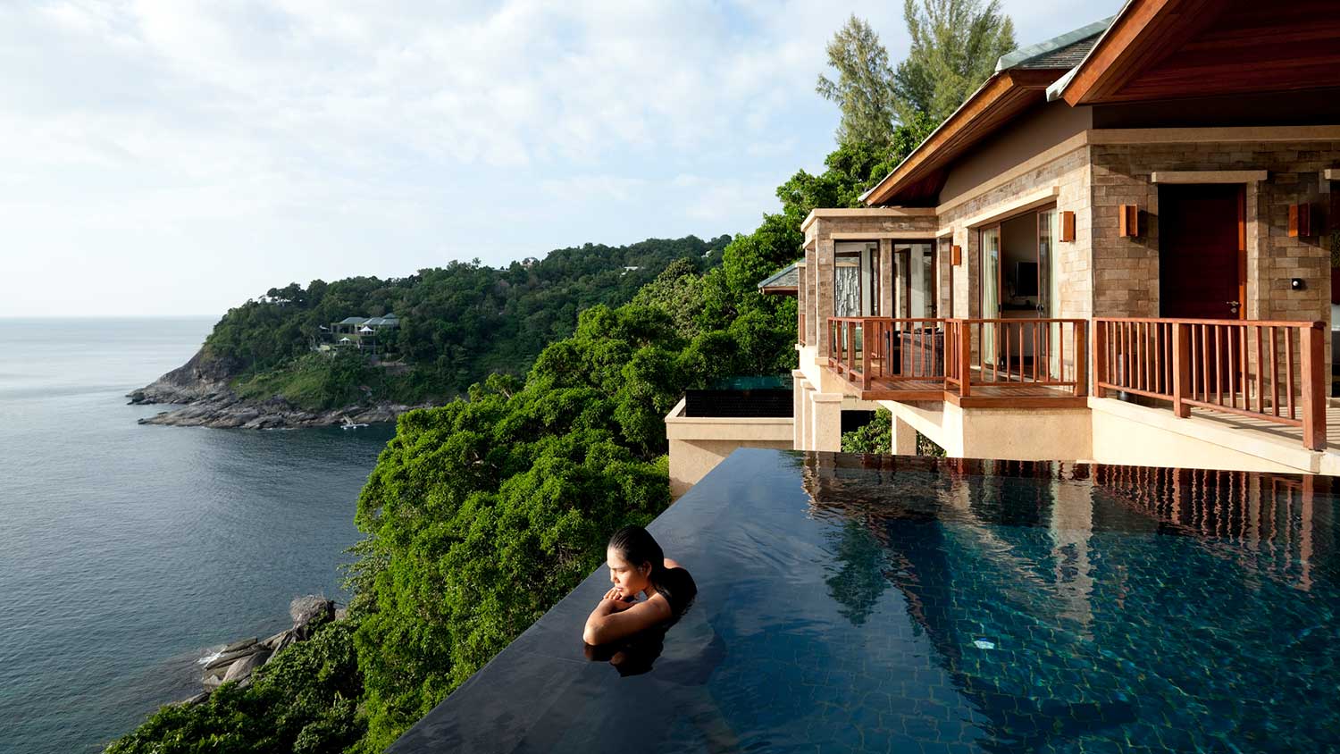 Woman swimming in an elevated infinity pool