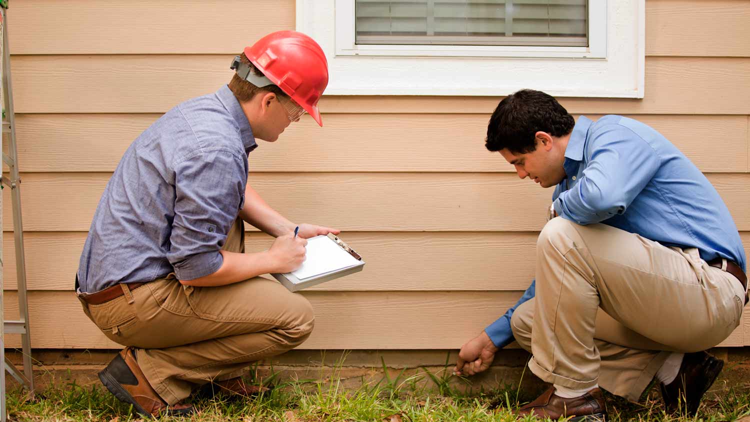contractor inspecting house foundation