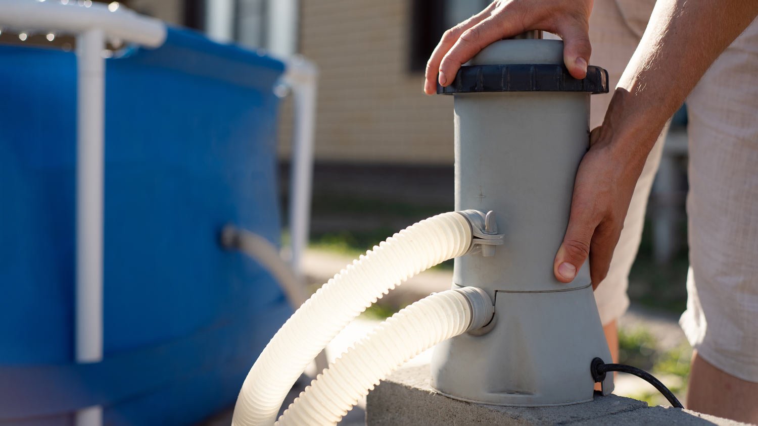 man checking pool filter