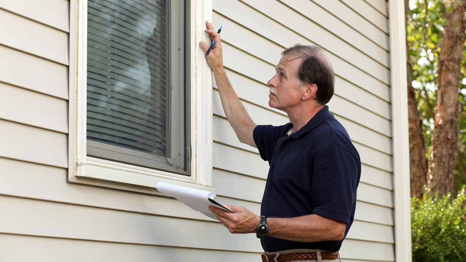 Home inspector checking mobile home exterior