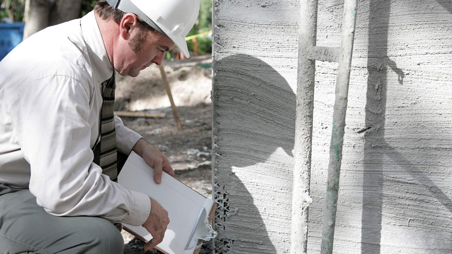 An inspector checking a house’s foundation