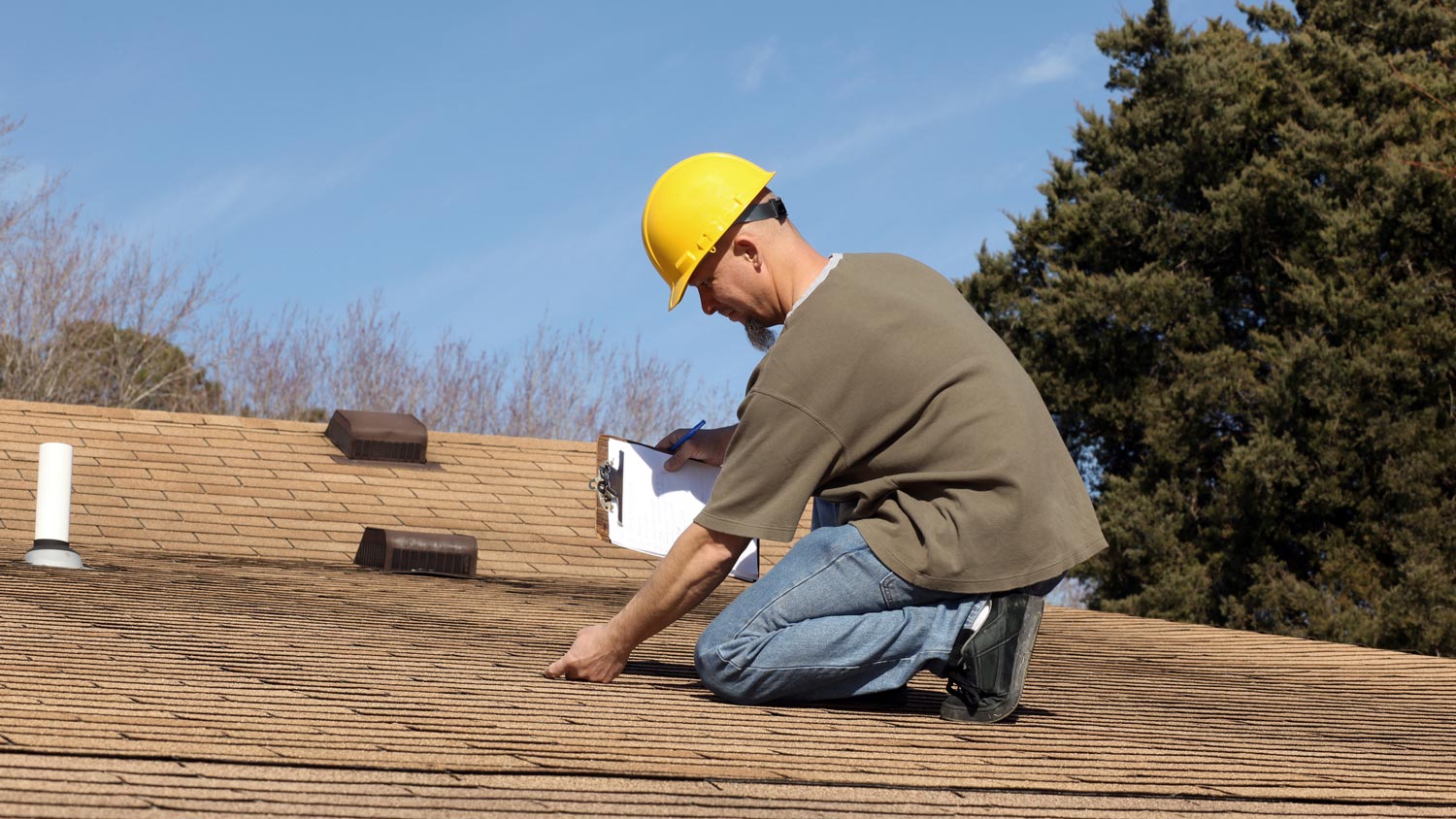 An inspector checking a house’s roof