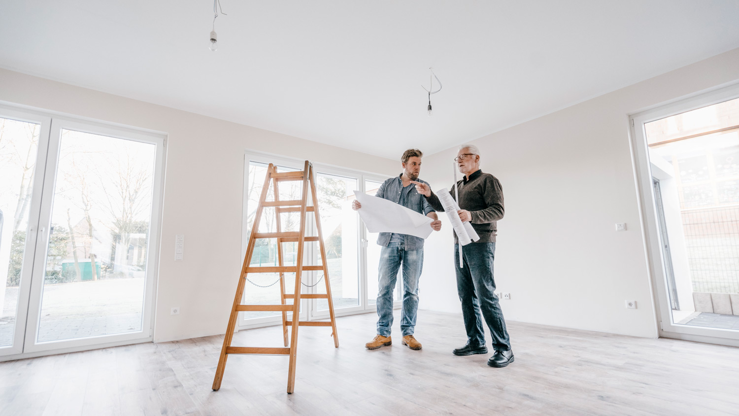 An inspector looking at plans with new homeowner