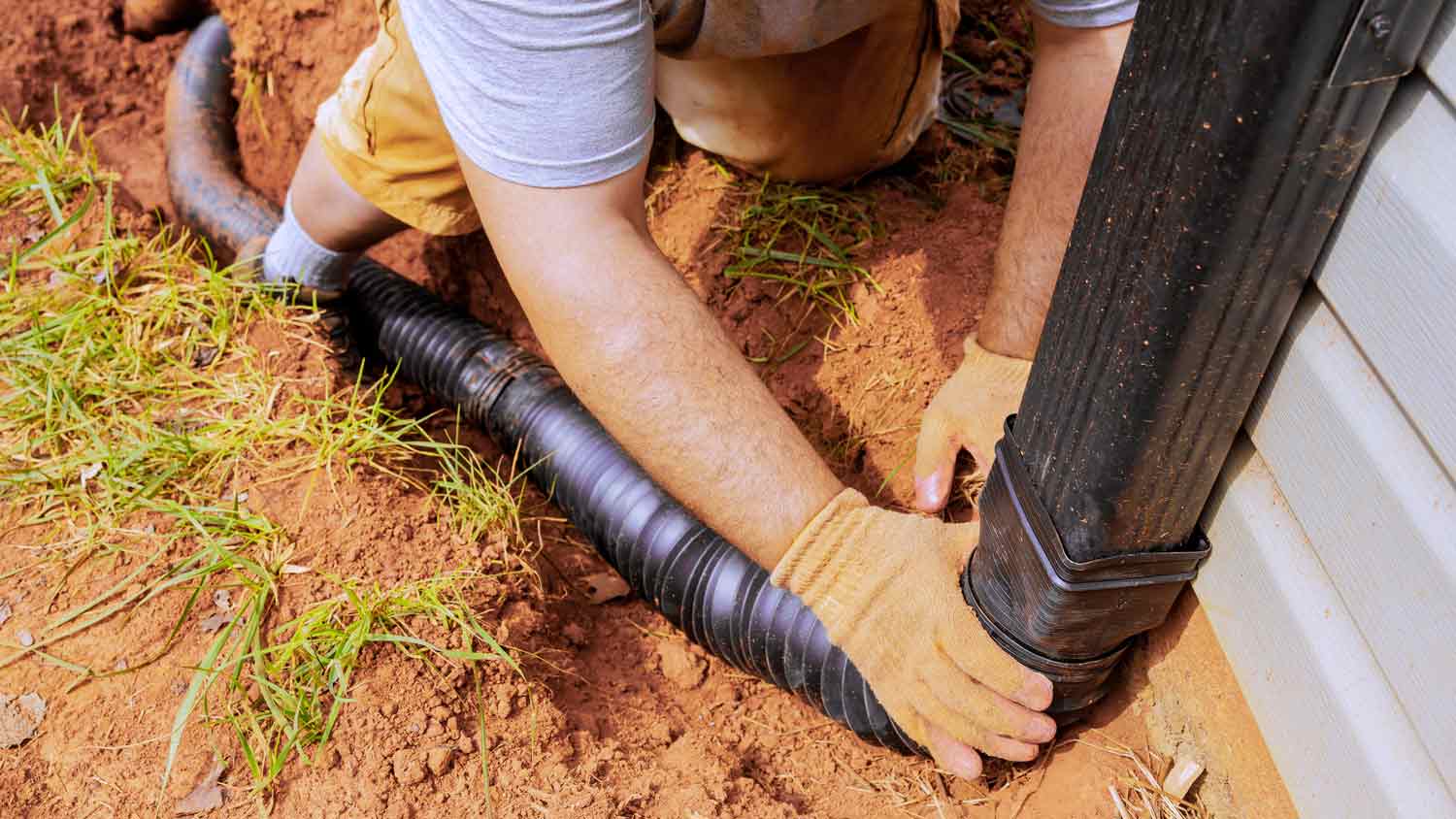 man installing gutter extension 