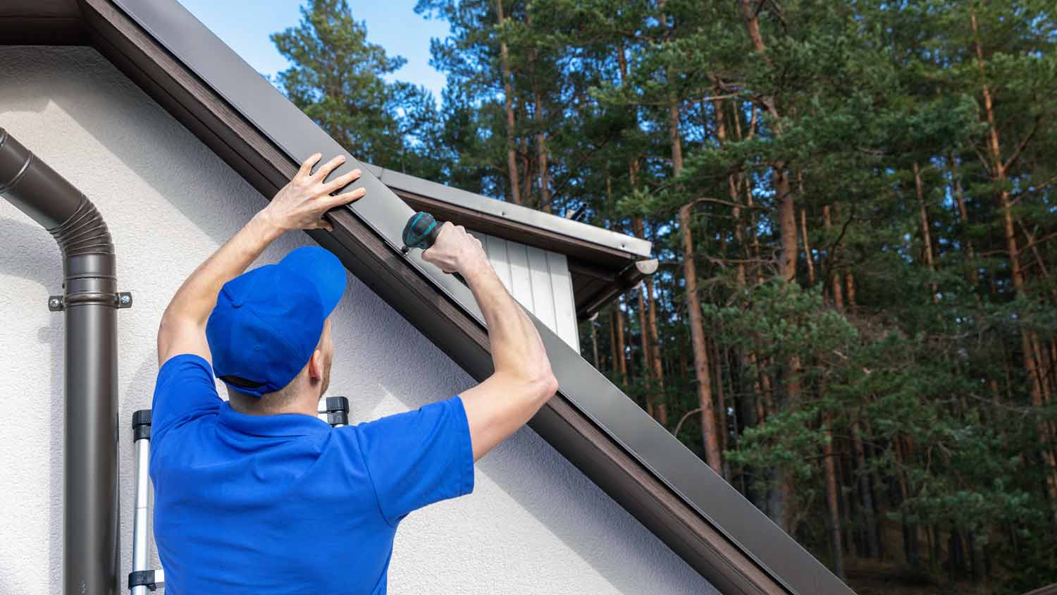 man installing metal drip edge 