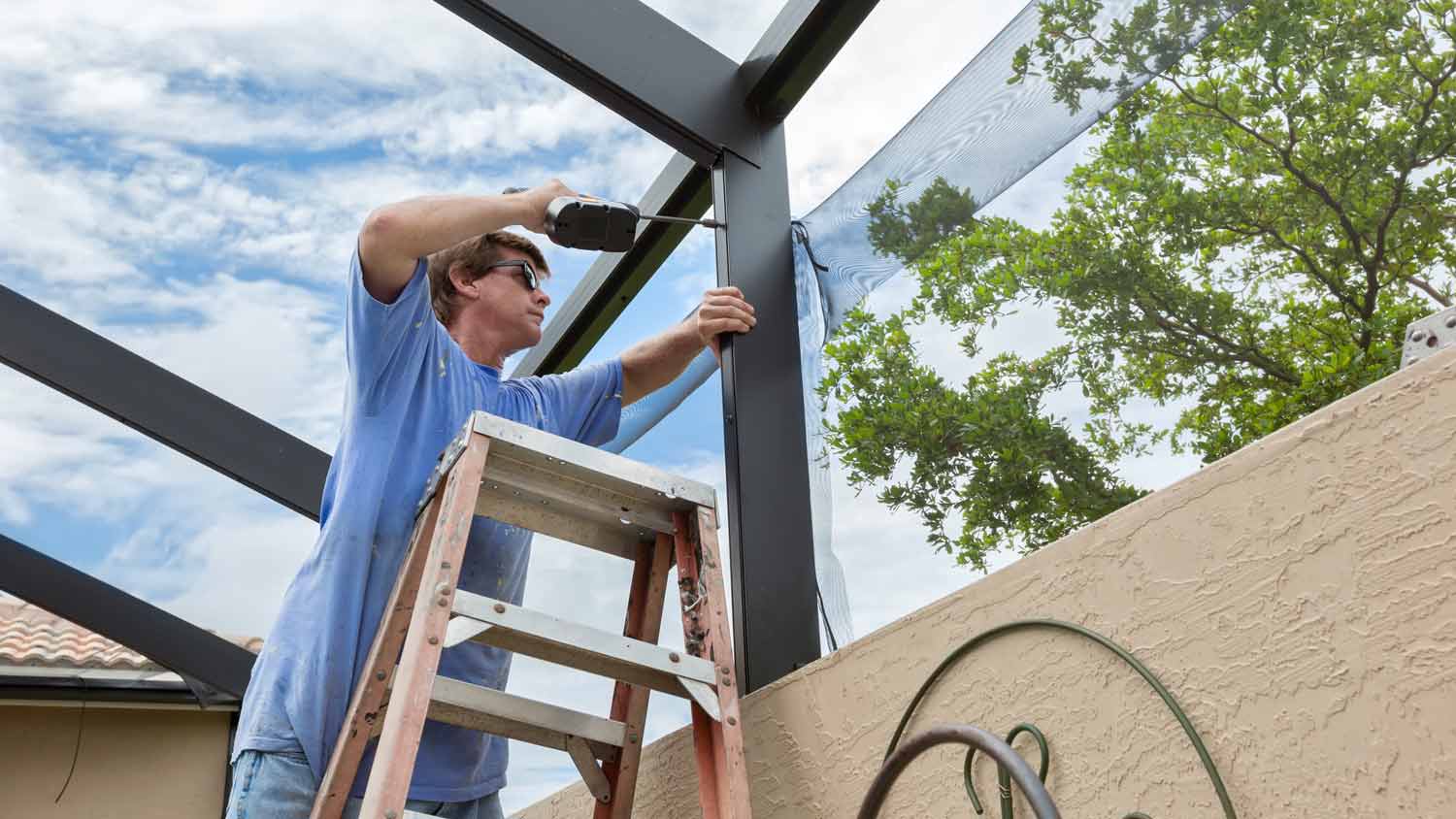 worker installing mesh pool screen