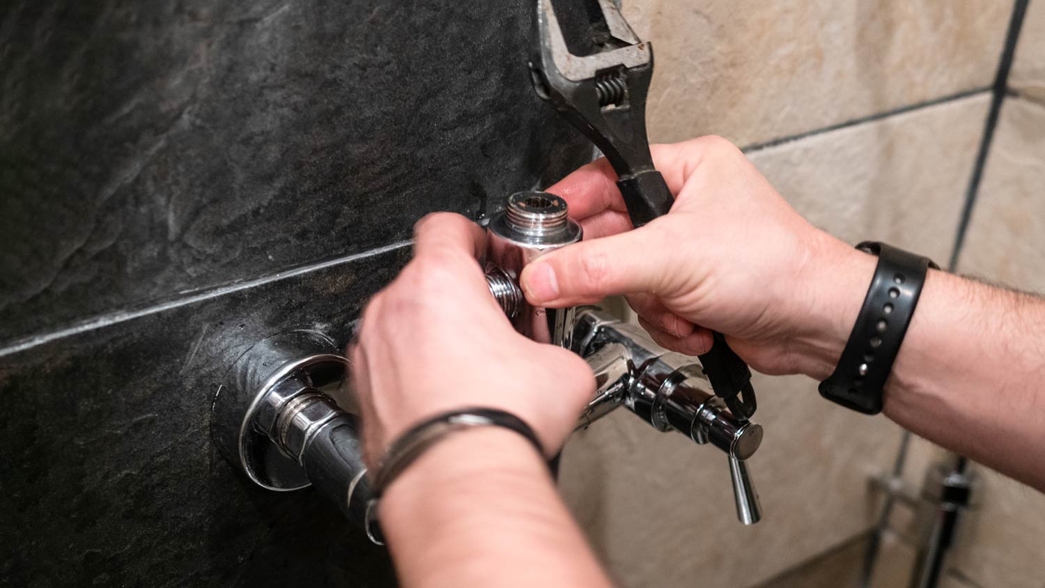plumber installing diverter on shower