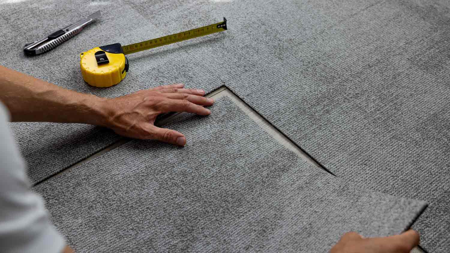 professional installing tile carpet