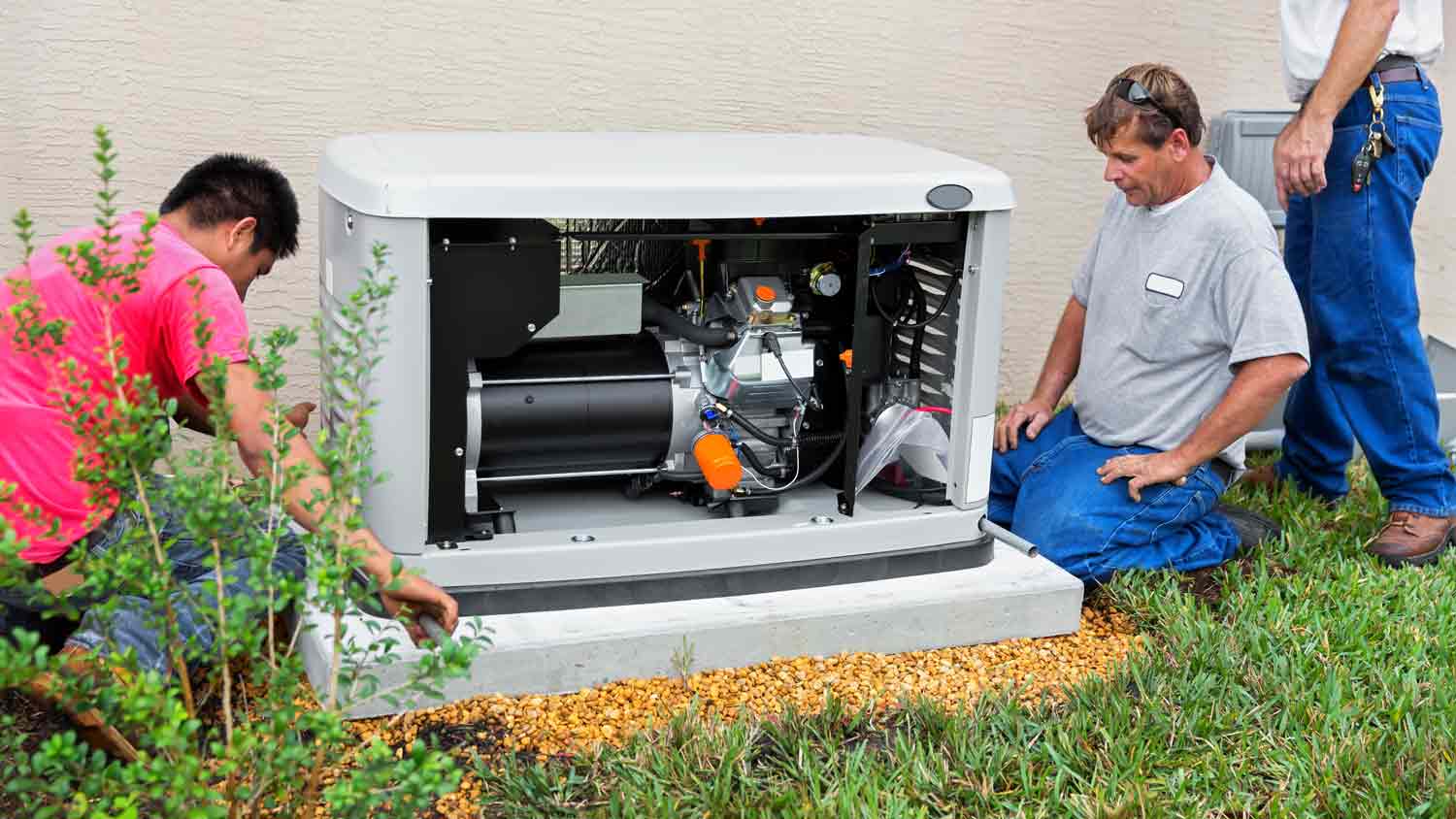 men installing whole house generator  