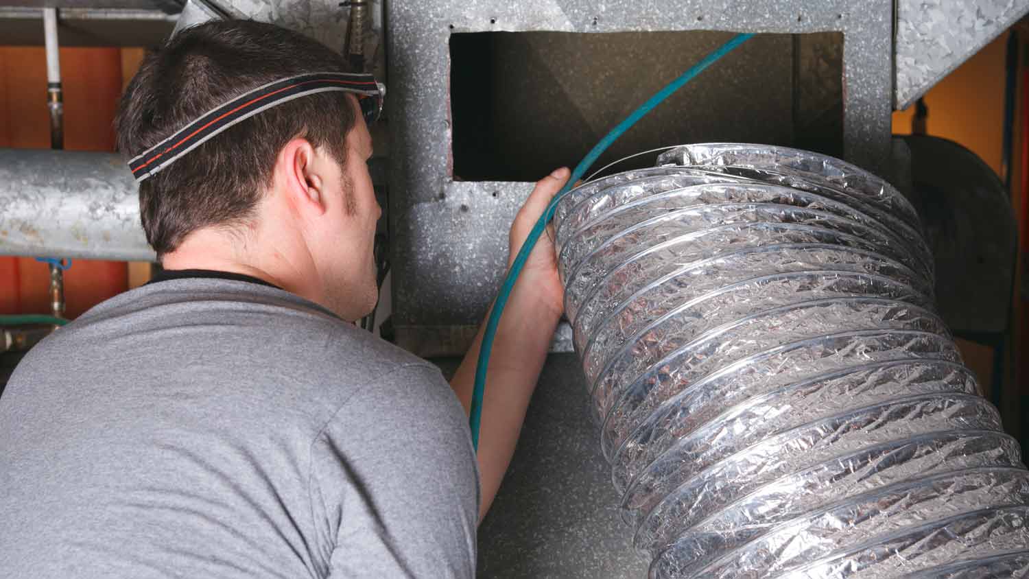 man installing air duct