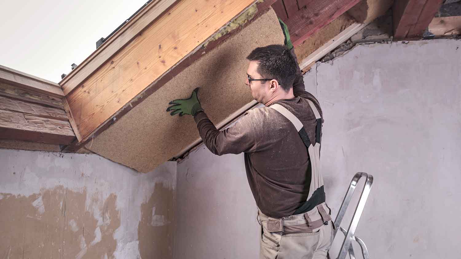 Man installing new insulation board