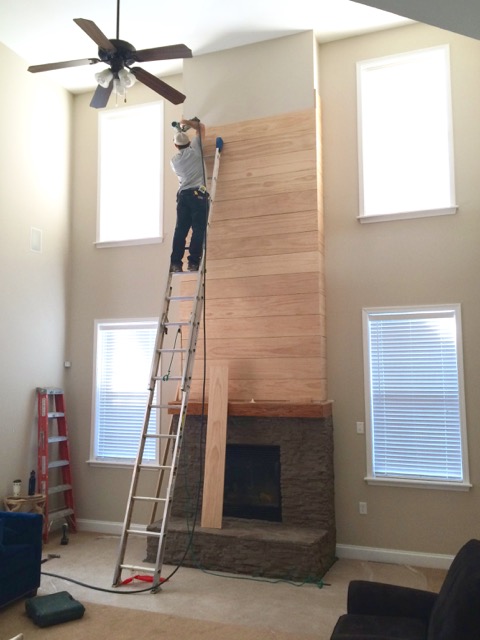 installing-shiplap-boards-up-chimney