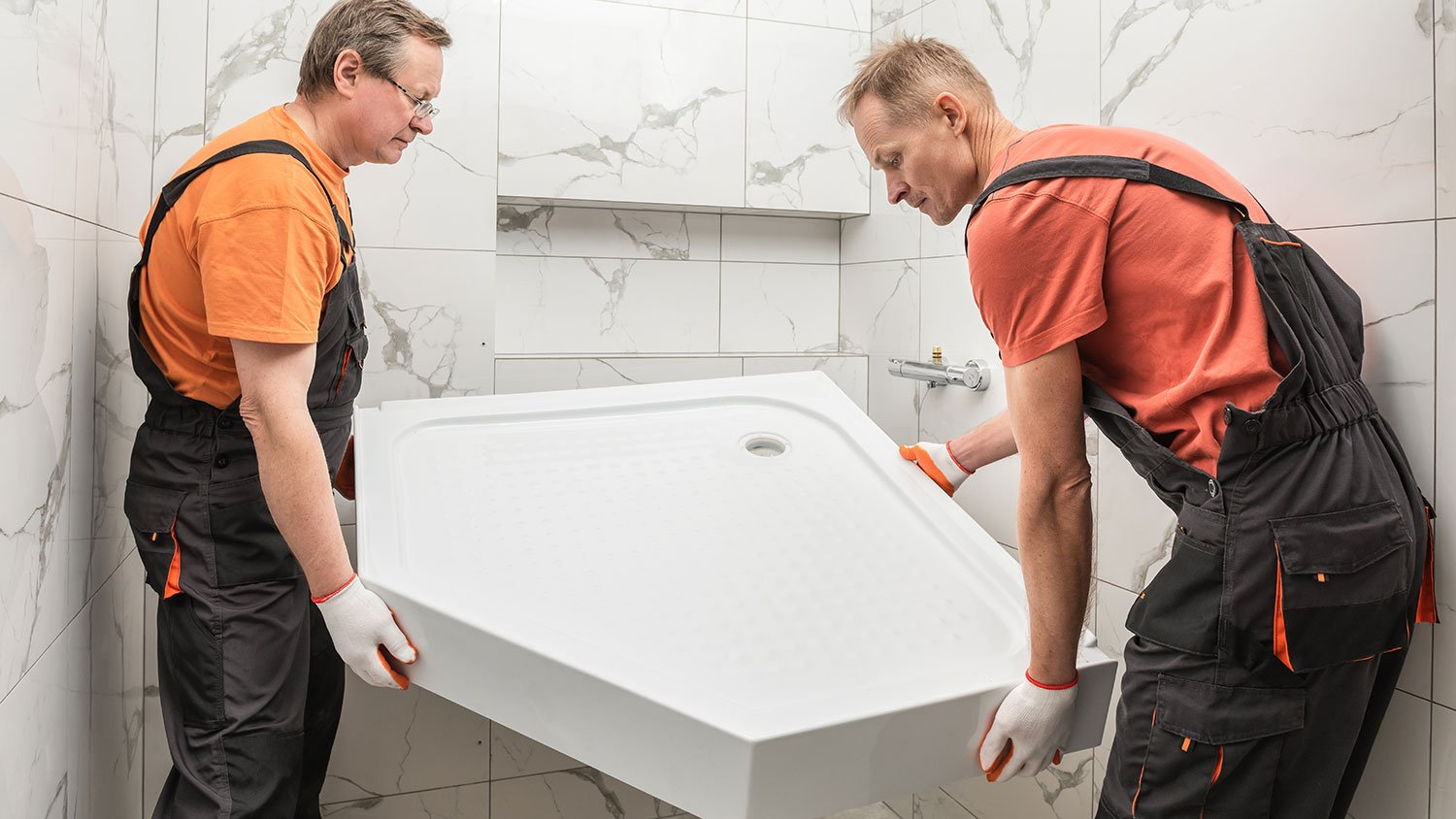 Workers installing new shower pan