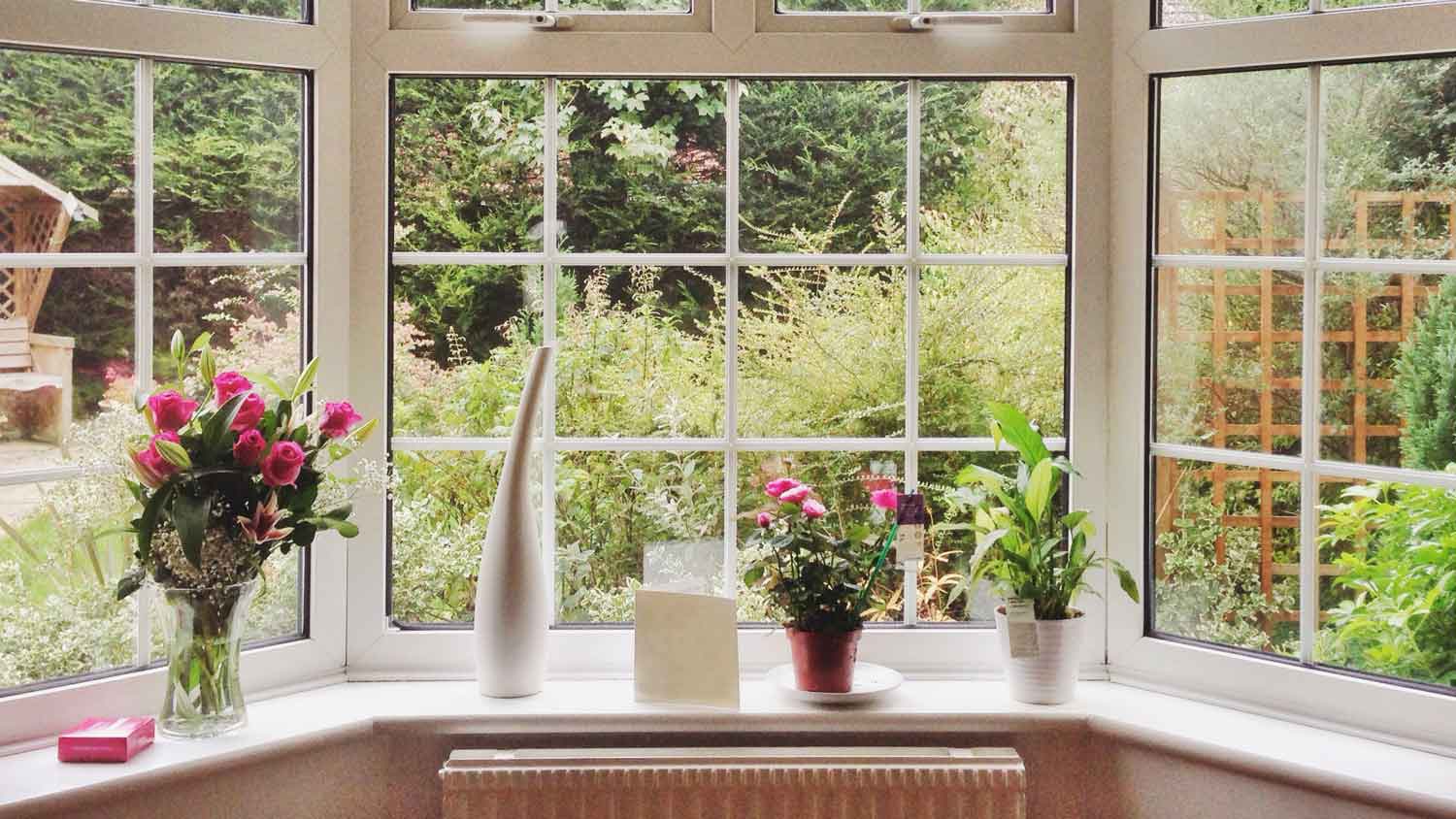 Interior shot of a bow window facing a lush garden