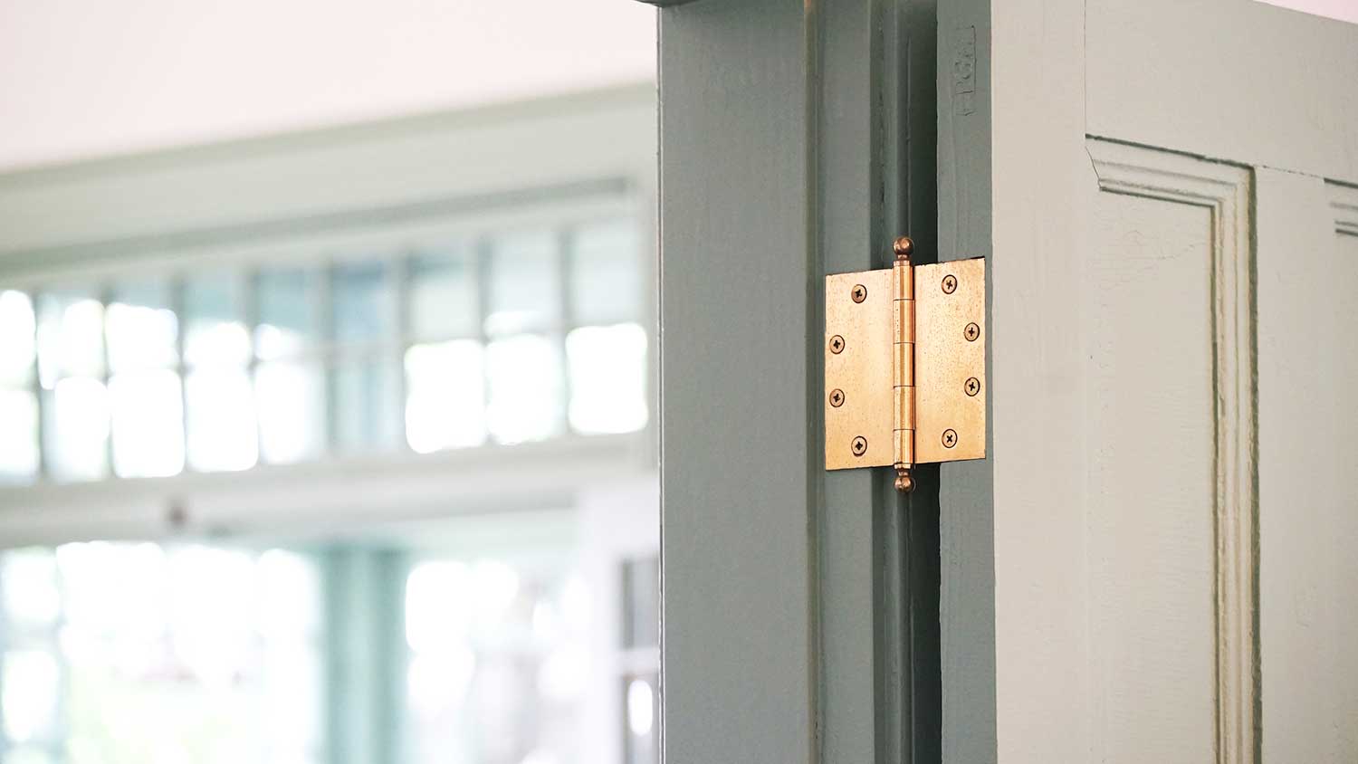 Brass hinge installed on an interior door