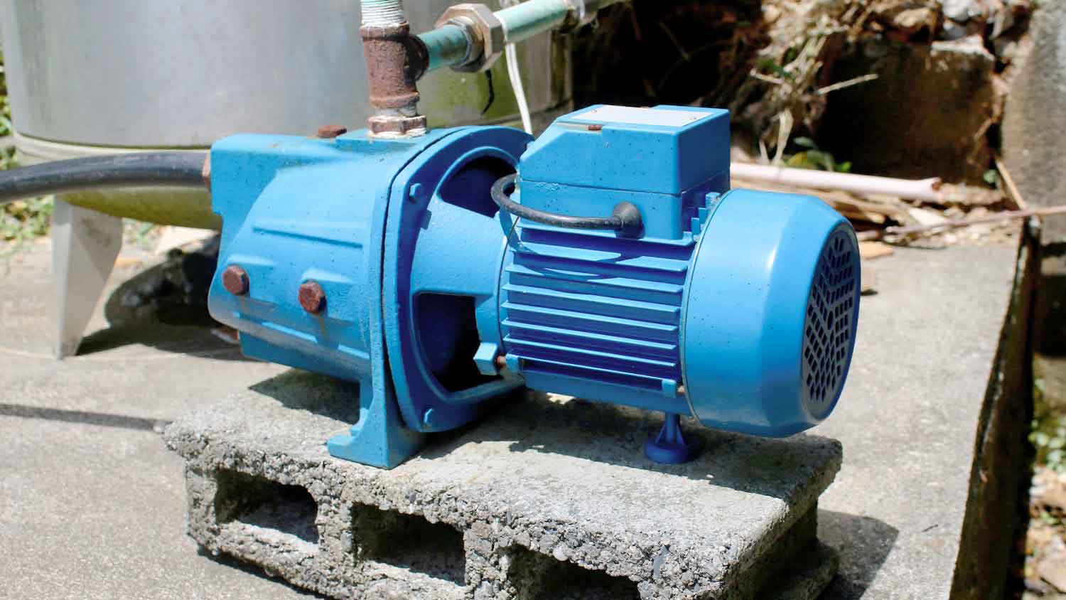 Jet well pump sitting on a cinderblock