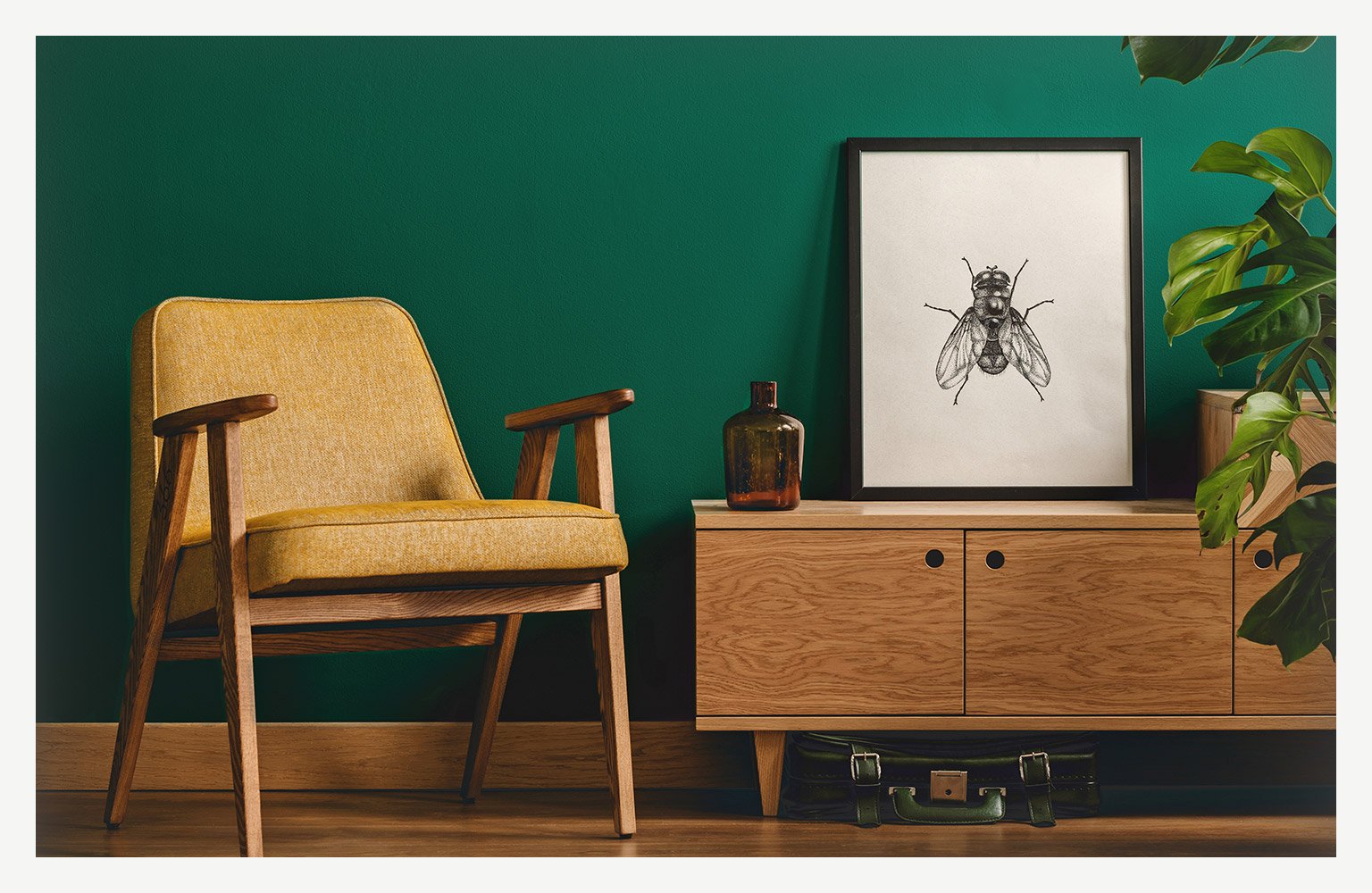 mustard yellow chair in front of emerald green wall in living room 