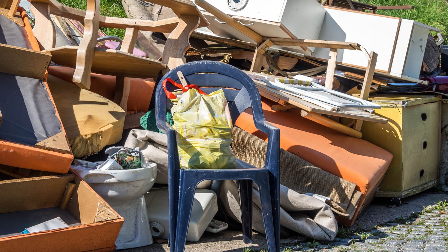 Pile of furniture and junk in yard