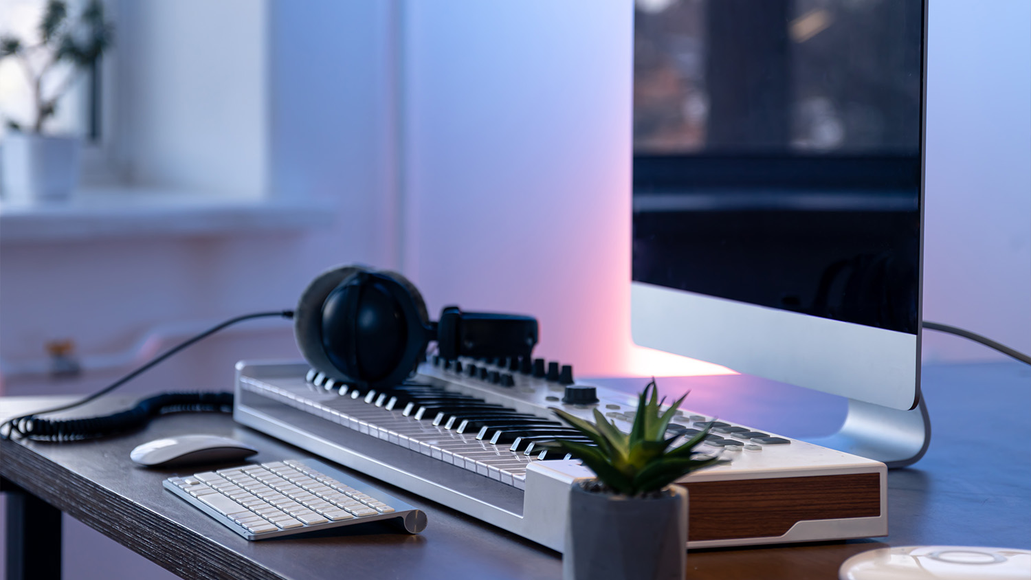 video game headphones sitting on desk with computer