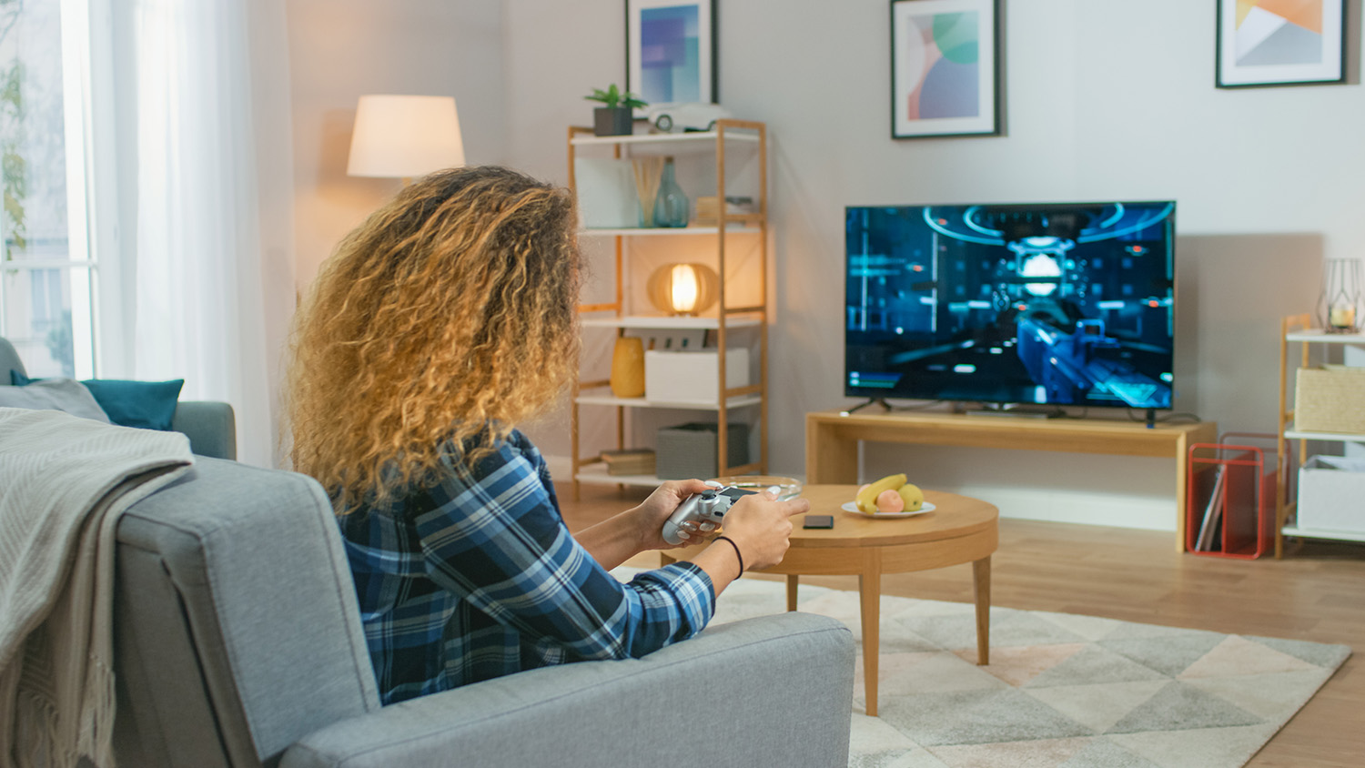 woman playing video games in living room