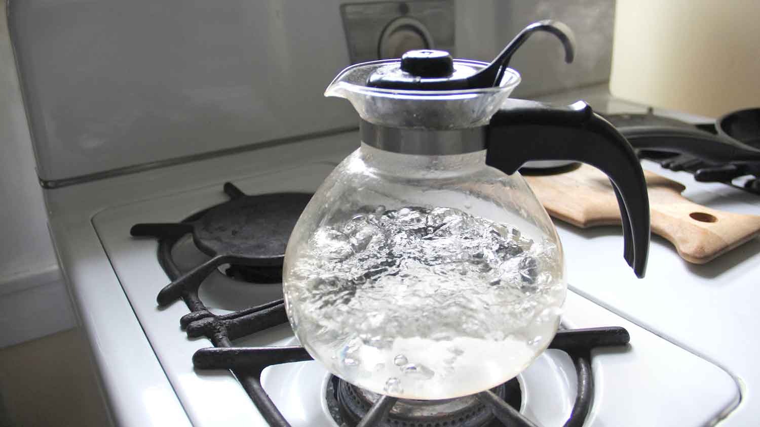 Glass tea kettle with boiling water