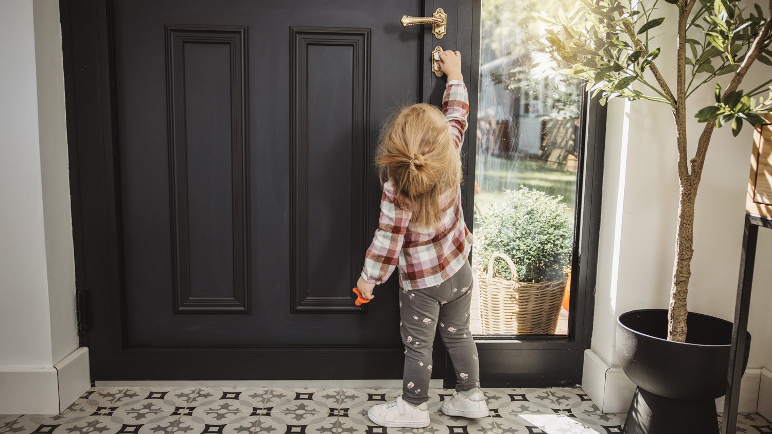 Little kid reaching for door handle