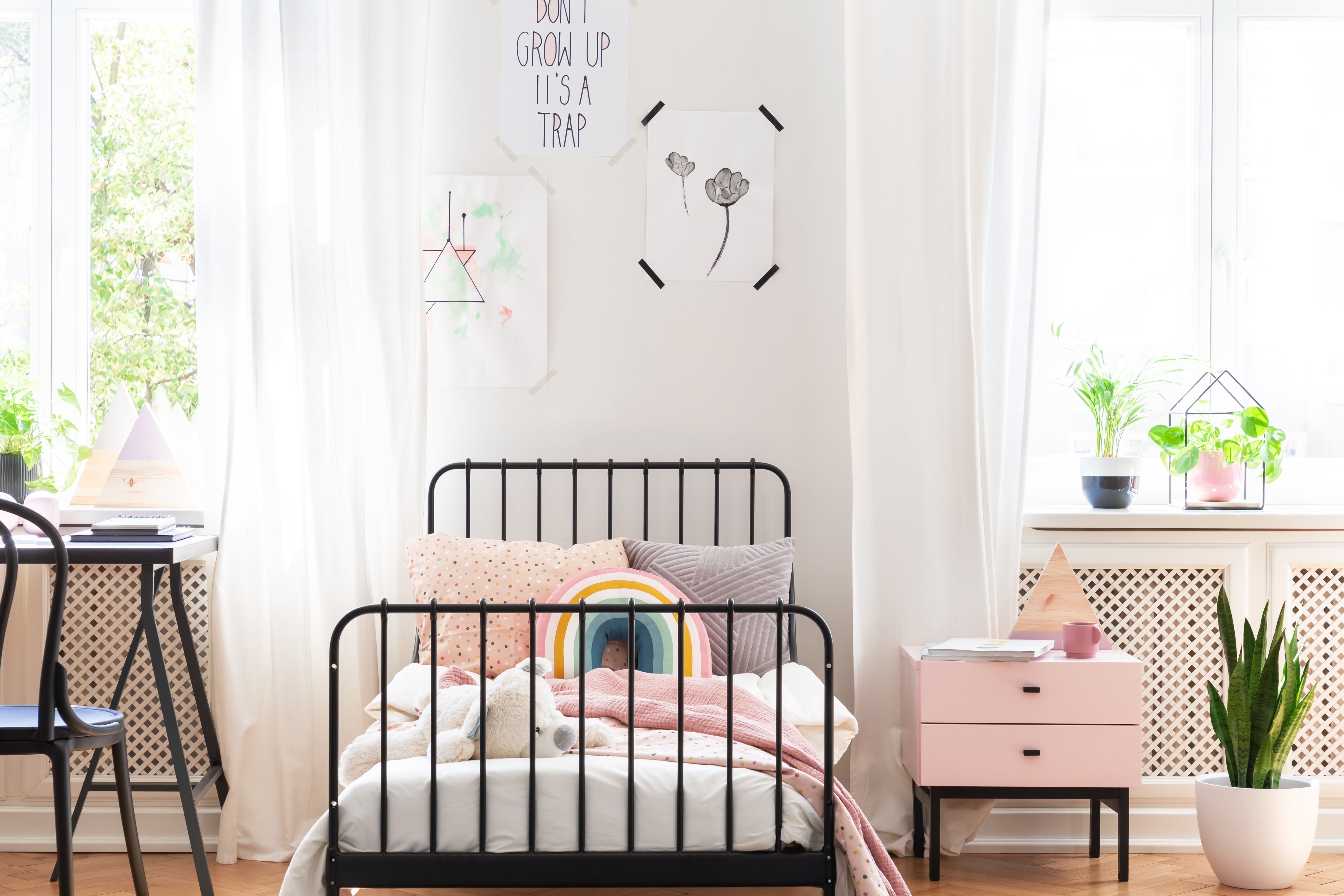 Pre-teen bedroom with decorative wall art and pillows