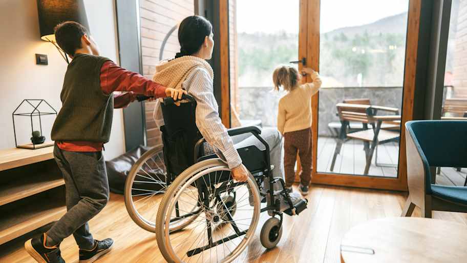 Woman in a wheelchair and kids going to the patio