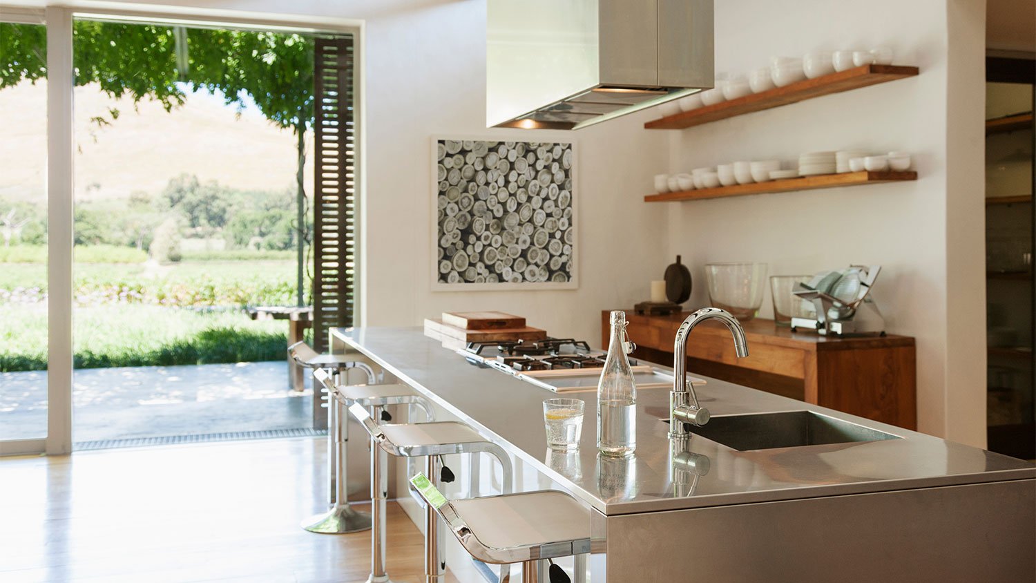 A view of a kitchen with chrome elements