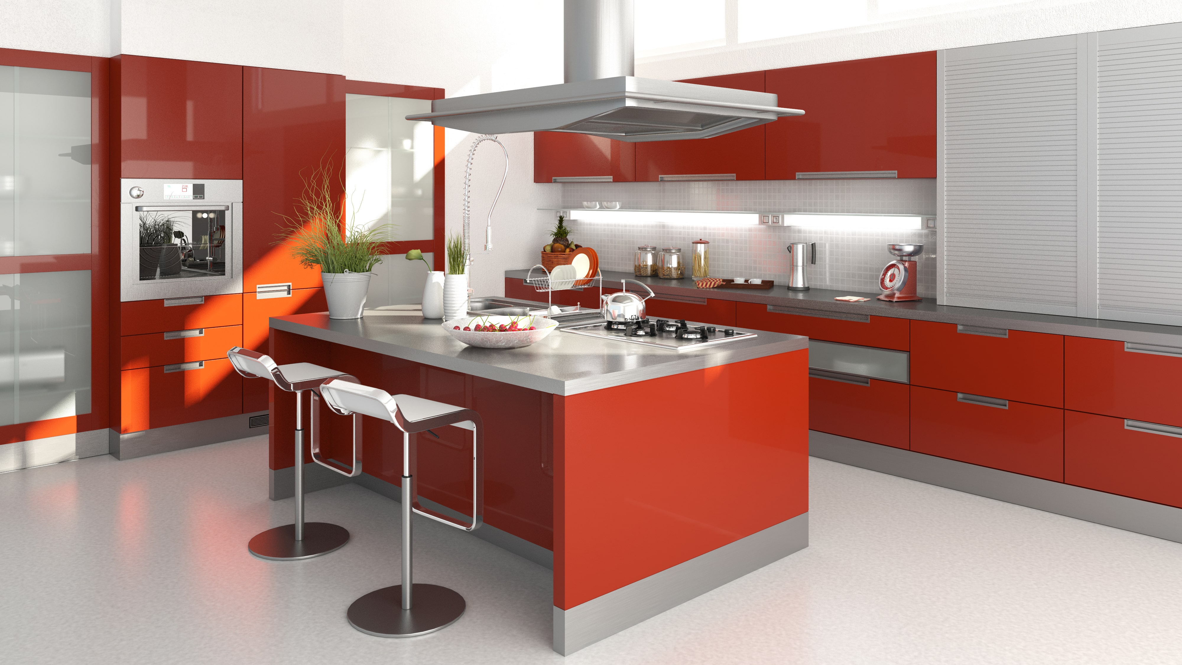 Modern kitchen with red cabinets, stainless steel countertops, a red kitchen island, and chrome barstools