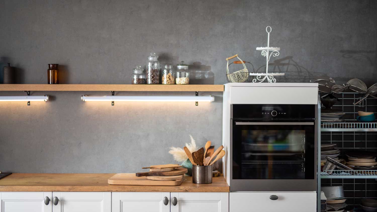 A kitchen wooden countertop with under shelves lighting