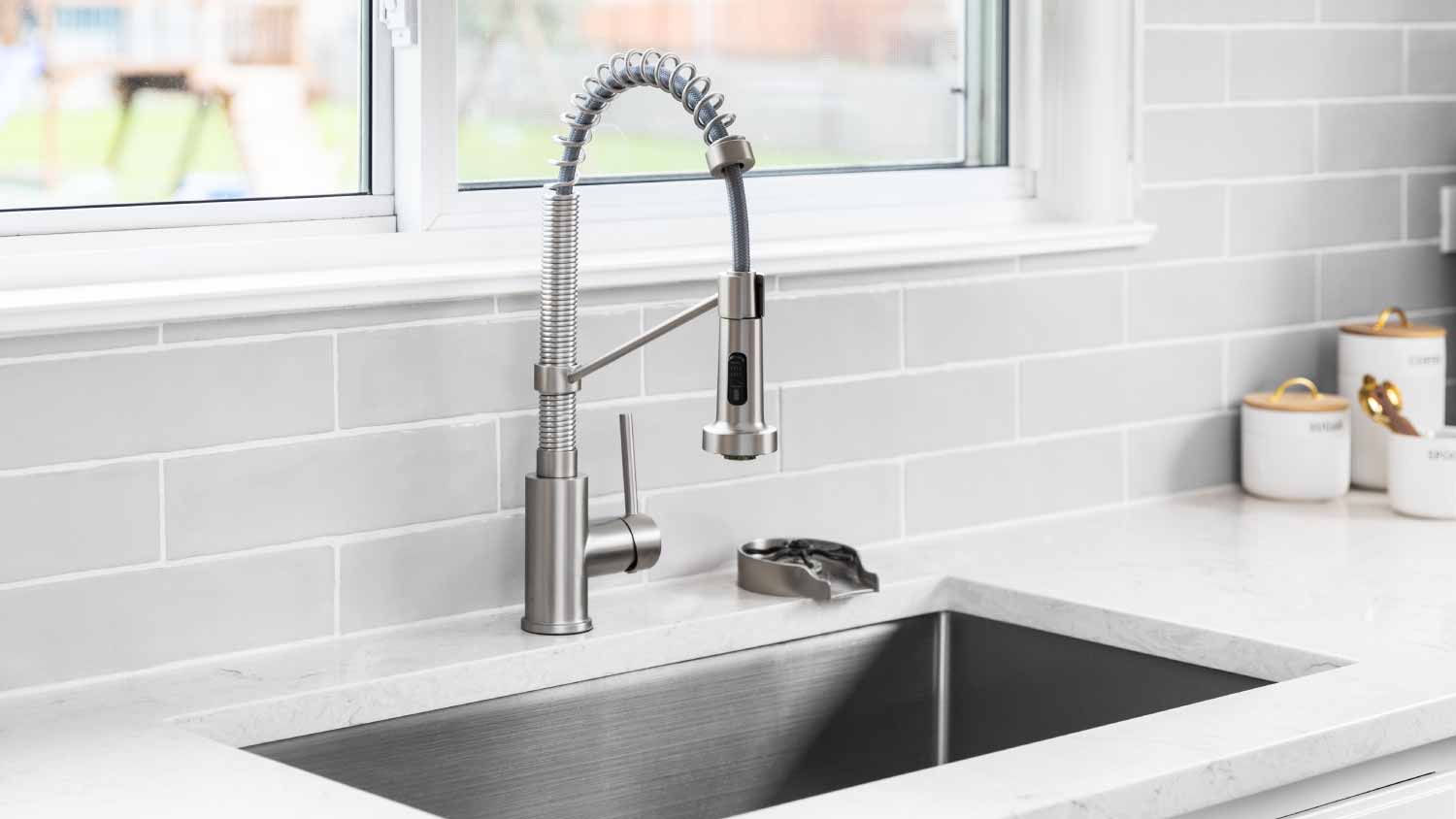 kitchen faucet detail with a marble countertop