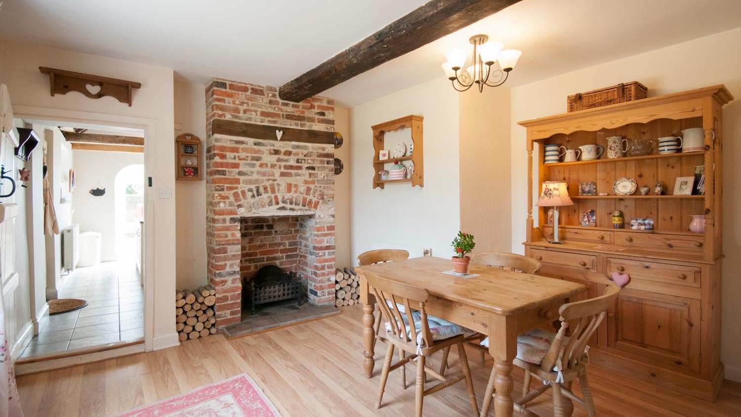 A kitchen with exposed brick fireplace