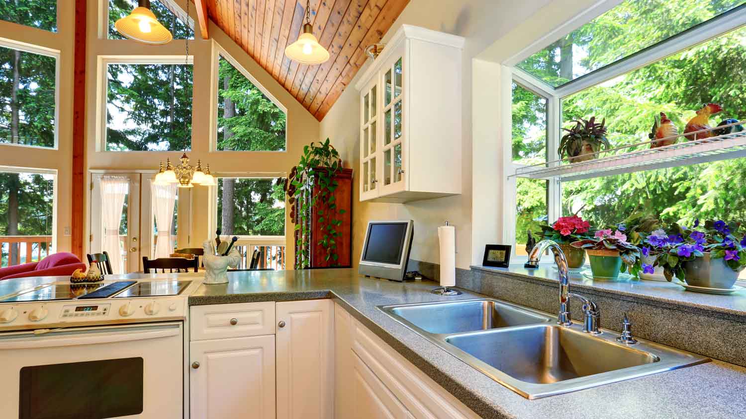 A kitchen with granite countertops and a garden window