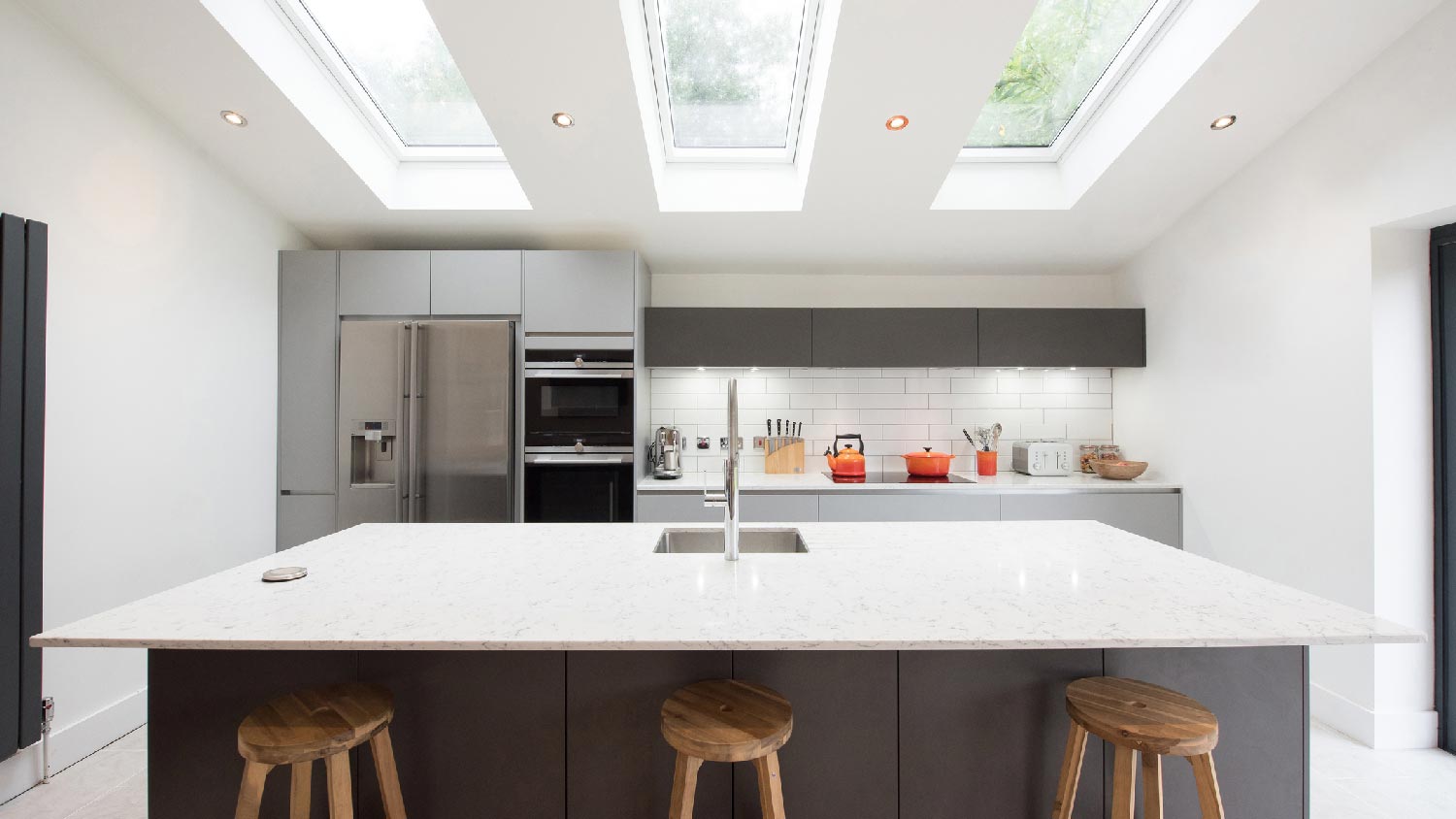 A kitchen with an island and skylight