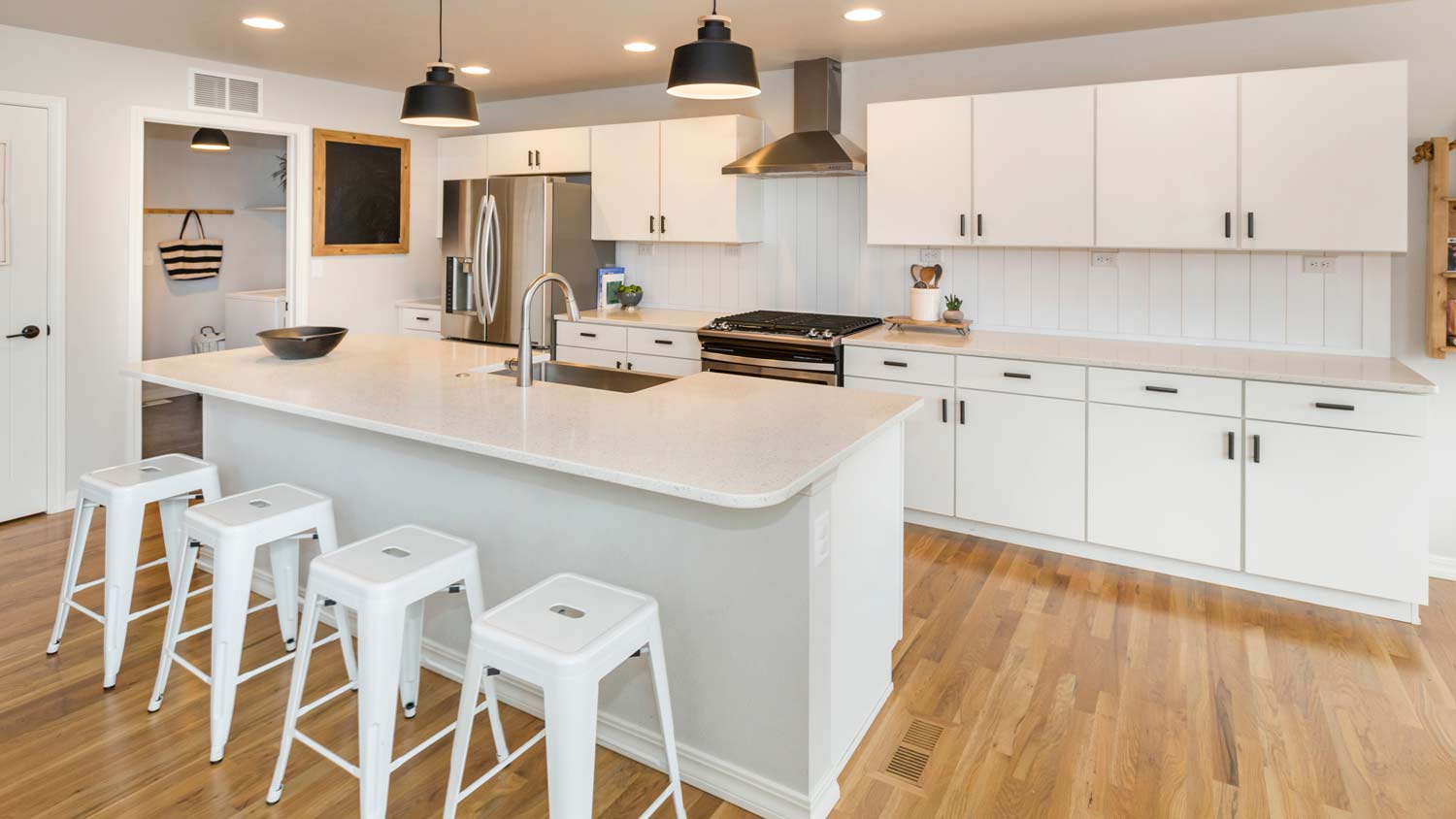 modern kitchen island with sink and stools