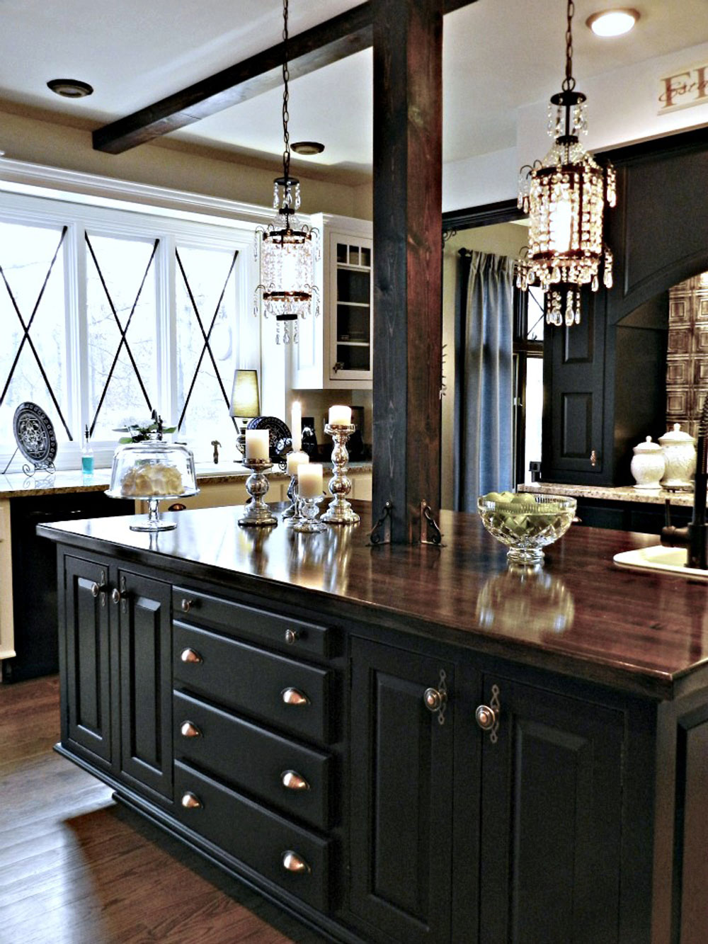 kitchen island with mahogany stained top and black cabinets