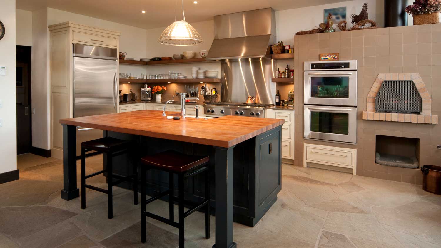 A kitchen with natural stone floor