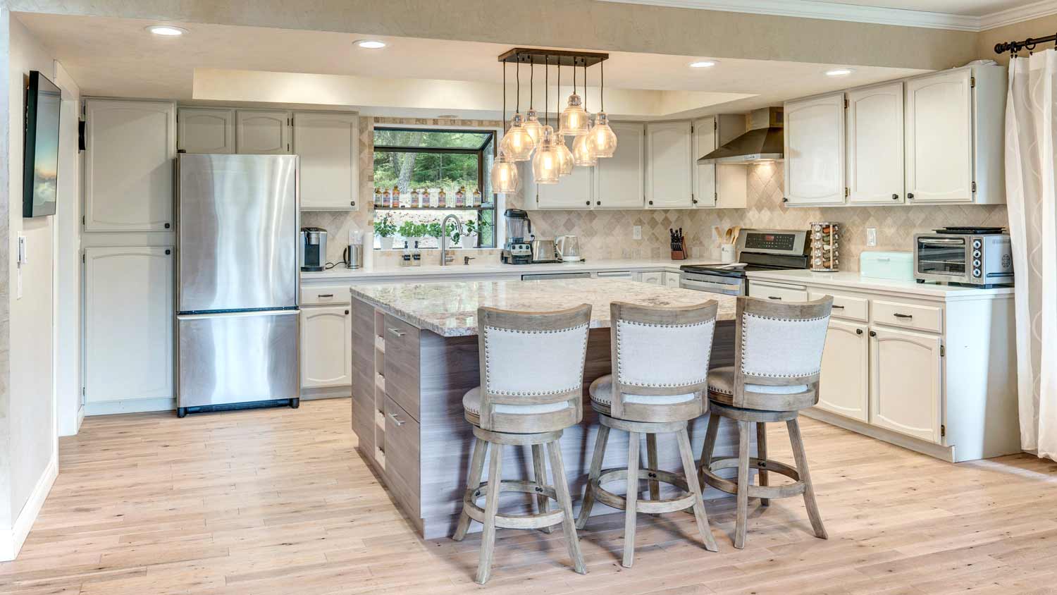 modern kitchen with pendant lighting over island